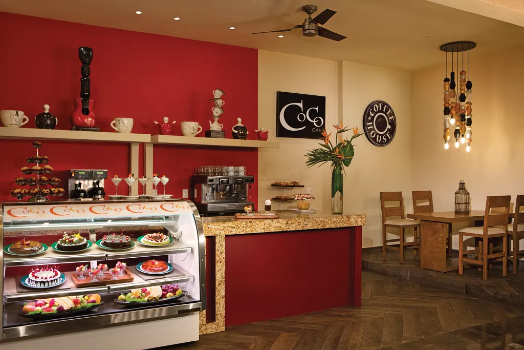 Coco Café at Sunscape Puerto Vallarta Resort & Spa featuring a 24-hour coffee shop with dessert display, espresso station, and casual seating.