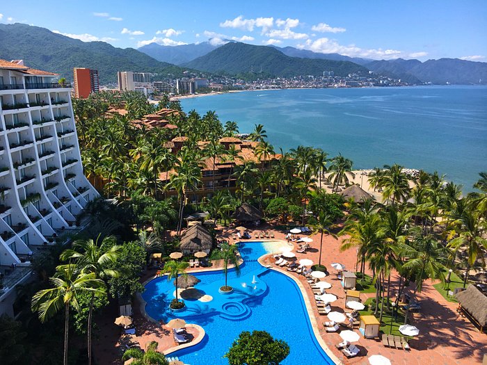 Fiesta Americana Puerto Vallarta All Inclusive beachfront resort with tropical pools, palapa restaurants, and sunset views over Banderas Bay.