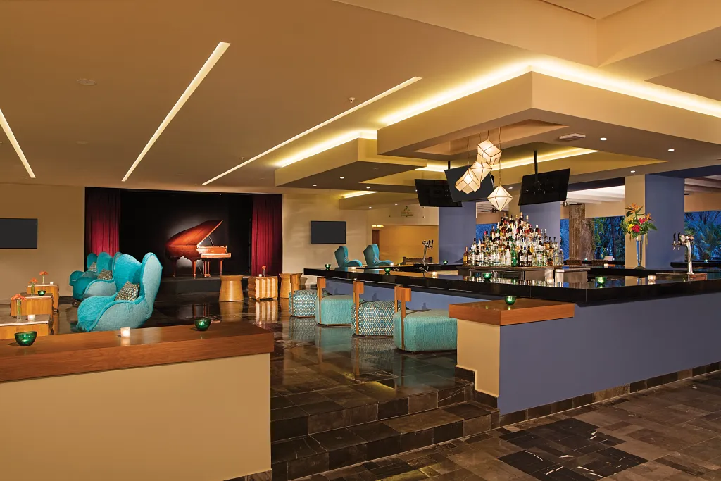 Rendezvous Lobby Bar at Sunscape Puerto Vallarta Resort & Spa featuring a modern lounge with full-service bar, live entertainment stage, and stylish seating.