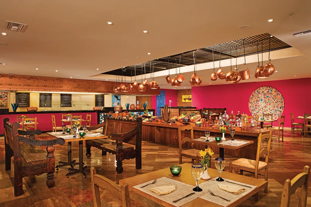 Tiki Taco Mexican Restaurant at Sunscape Puerto Vallarta Resort & Spa featuring a colorful dining room with rustic décor, open kitchen, and traditional Mexican ambiance.